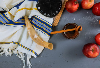 Apple, pomegranate and honey of jewish New Year Rosh Hashana torah book, kippah yamolka talit