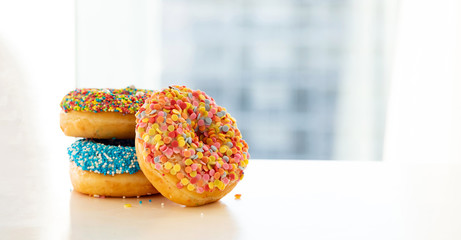 Doughnuts on white color table. Closeup view
