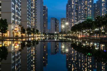 Fototapeta na wymiar Twilight scene of modern city with buildings and reflection on lake in Hanoi, Vietnam