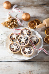Homemade festive mince pies on white plate © marysckin