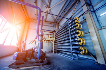 Interior of modern natural oil factory. The piping, pumps and motors