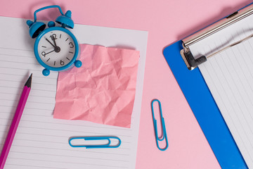 Paper sheet note clipboard pencil clips alarm clock colored background