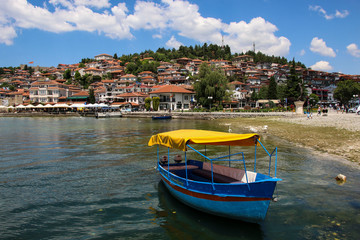 Fishing boat in the background historical part town Ohrid, UNESCO heritage listed, Republic of North Macedonia - obrazy, fototapety, plakaty