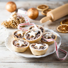 Homemade festive mince pies on white plate © marysckin