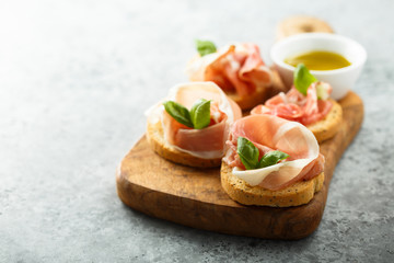Italian appetizers with Parma ham and basil