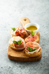 Italian appetizers with Parma ham and basil