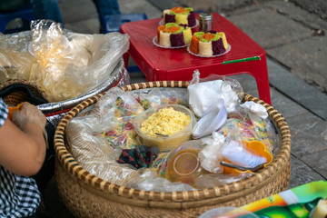 Vietnamese steamed glutinous rice in bowl for vendor sale on Hanoi street. Xoi xeo in Vietnamese