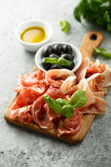 Charcuterie board with fresh basil