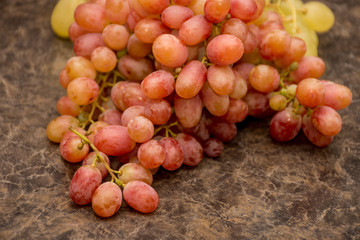 Red and white ripe grapes on dark marble background