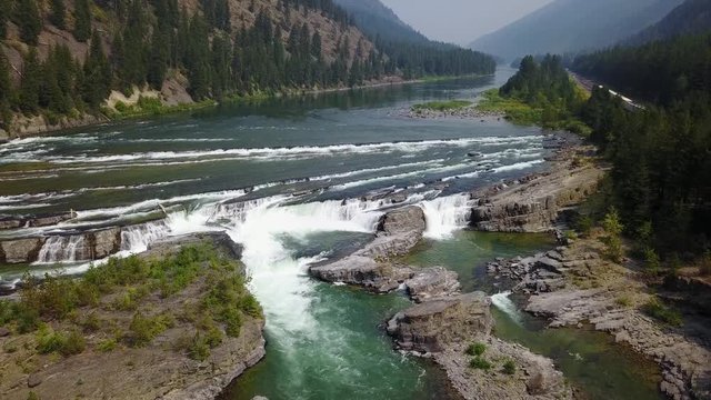 the water falls, aerial drone footage, downward view going upward, Kootenai falls, Montana. v03