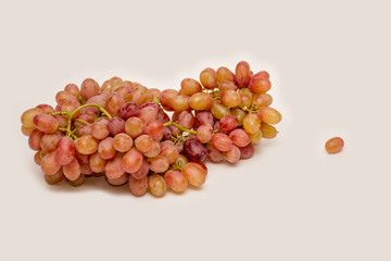 Red ripe grapes on neutral background