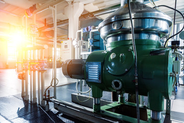 Interior of modern natural oil factory. The piping, pumps and motors