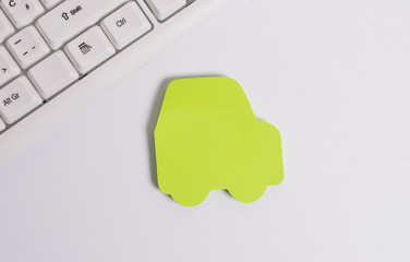Green empty note paper in the shape of the car. Copy space on the green note paper.