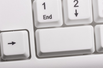 White pc keyboard with empty note paper above white background key copy space