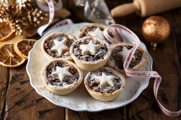 Homemade festive mince pies on white plate © marysckin