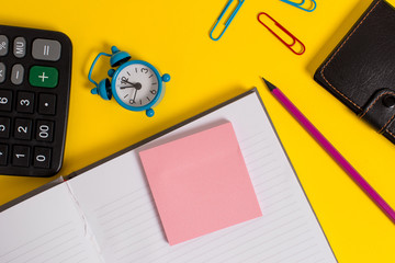 Notebook wallet calculator clips pencil note alarm clock color background