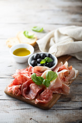 Charcuterie board with fresh basil