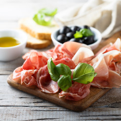 Charcuterie board with fresh basil