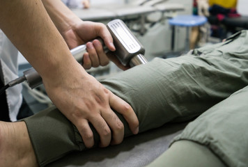 The doctor is rehabilitating the patient's legs