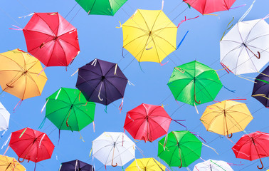 Fototapeta na wymiar Summer mood with colorful umbrellas in the street