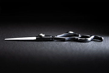 professional scissors on black background