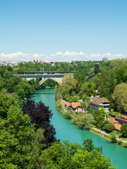 Fototapeta premium Bern, Switzerland - Jun 1st 2019: .The Aare river flows around three sides of the city of Bern. With its crystal-clear turquoise water