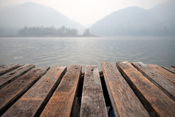 Fototapeta premium Wooden bridge for passenger boat landing in the reservoir