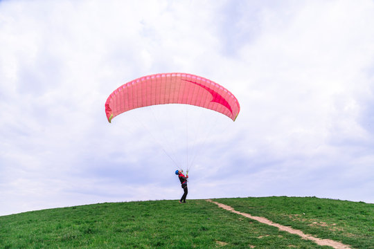 Man landed and tries to drop parachute on ground
