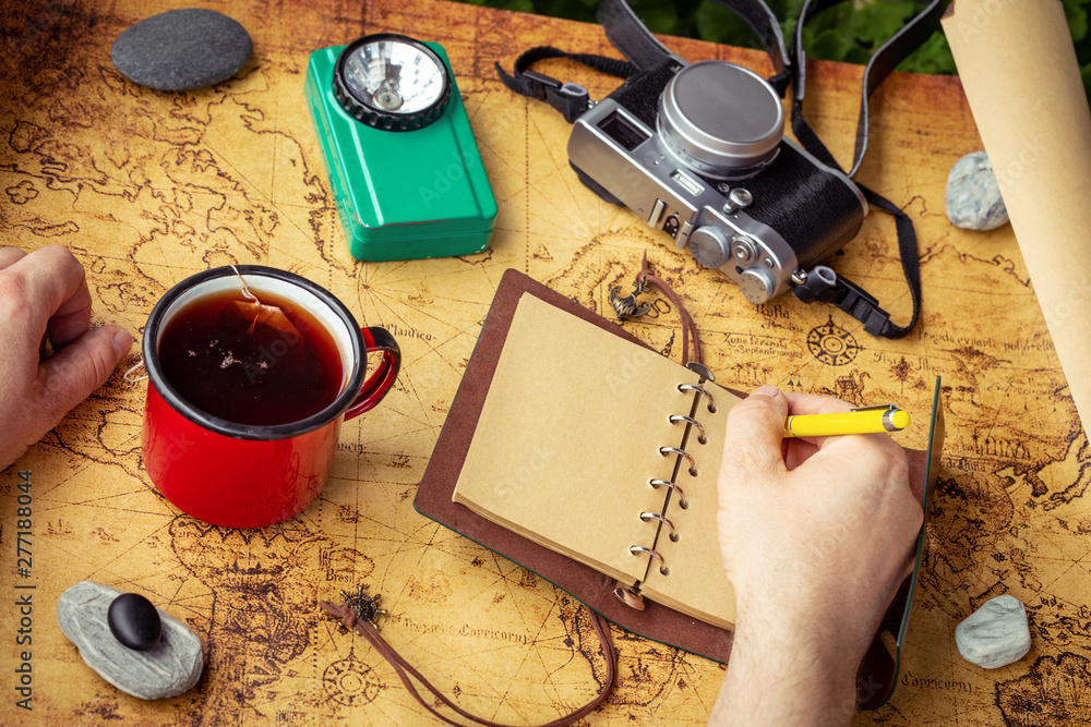 Poster a map with a travel notebook and travel equipment in a retro style. journey plan