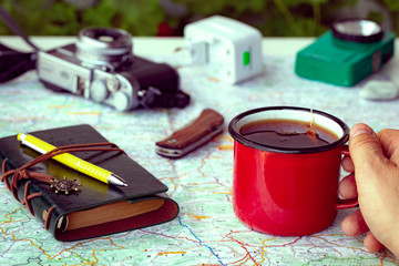 a map with a travel notebook and travel equipment in a retro style. Journey plan