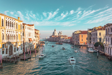 Fototapeta na wymiar Grand Canal in Venice, Italy. View of the main street panorama of the major street of Venice, picturesque clouds in the sky. Basilica di Santa Maria della Salute.