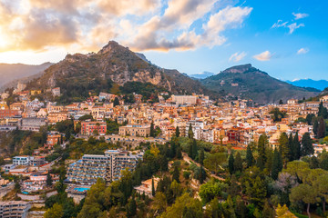 Obraz premium Taormina is a town on the island of Sicily, Italy. Aerial View from above in the evening to temper at the foot of the mountains.