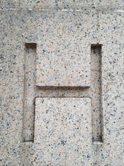 Carved letter H in stone