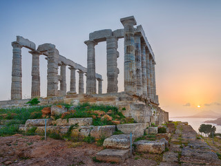 View to ruins with columns of temple Poseidon in sunset time in Greece