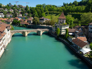 Fototapeta na wymiar Bern, Switzerland - Jun 2nd 2019: .The Aare river flows around three sides of the city of Bern. With its crystal-clear turquoise water