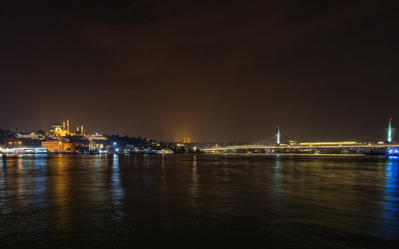 Istanbul night panorma viewed form Galata Bridge with the illuminated Suleymaniye Mosque, Turkey