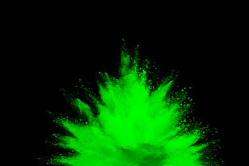 Green powder explosion on black background. Colored cloud. Color dust explode. Paint Holi.