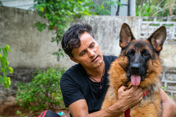 German Shepherd with Handler in Garden