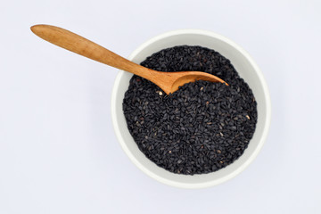 Poppy in a white cup with a wooden spoon on a white background