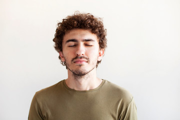 closed,man,portrait,white,smiling,background,camera,curly,face,head,isolated,shoulders,20-24,25-29,adult,sandat,casual,caucasian,confidence,copy,cut,cute,day,dreaming,energy,exhilaration