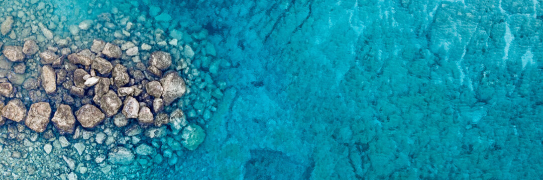 An aerial view of the beautiful Mediterranean sea, where you can se the rocky textured underwater corals and the clean turquoise water of Protaras, Cyprus