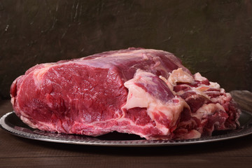 A big piece of raw meat for a steak in a dish