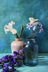 Still life with white and blue irises in a ceramic vase. Tinted.