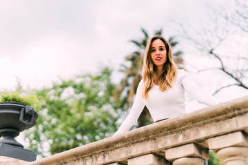 Naklejka premium Young pretty woman in sunny summer park