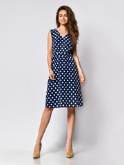 Woman in polka dot Dress in Fashion Store - Portrait of girl in a clothes shop in a midi summer dress