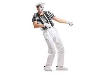 Mime pulling an imaginary rope