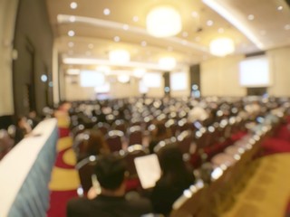 Abstract blurred image of people in seminar room or conference hall for profession seminar and the...