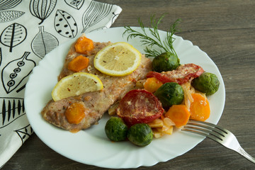 Baked white fish with lemon, cabbage, carrots, tomatoes, potatoes