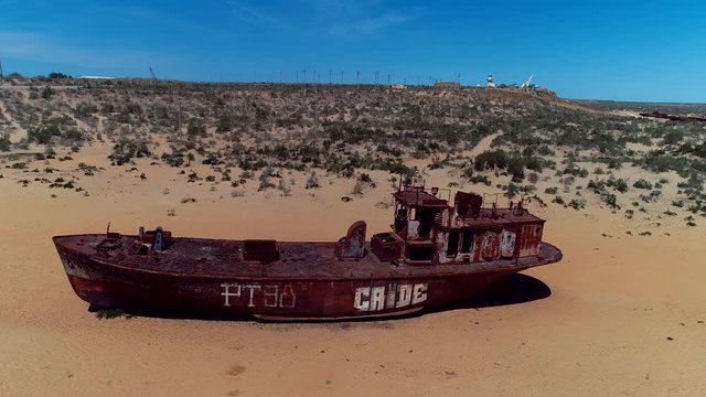 Real model of former sea boat on a pedestal as monument of passed days when Mo'ynoq was an active sea port on Aral sea. Picture taken in former piscatorial port Mo'ynoq Moynaq or Muynak, Uzbekistan.