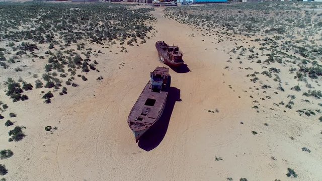 Real model of former sea boat on a pedestal as monument of passed days when Mo'ynoq was an active sea port on Aral sea. Picture taken in former piscatorial port Mo'ynoq Moynaq or Muynak, Uzbekistan.